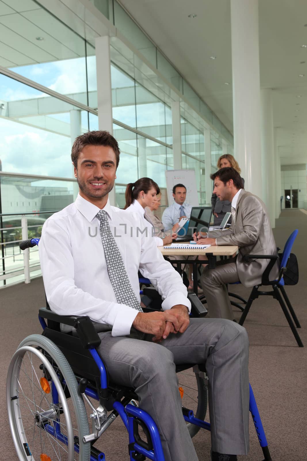 Businessman in wheelchair by phovoir