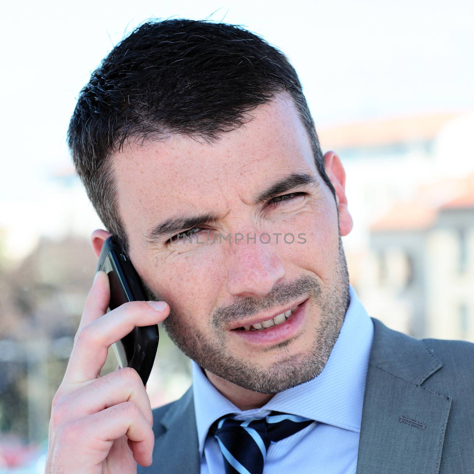 portrait of businessman on the phone outdoor