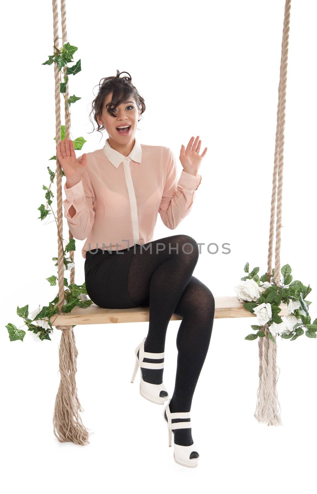 Emotional woman on a swing in the studio isolated background