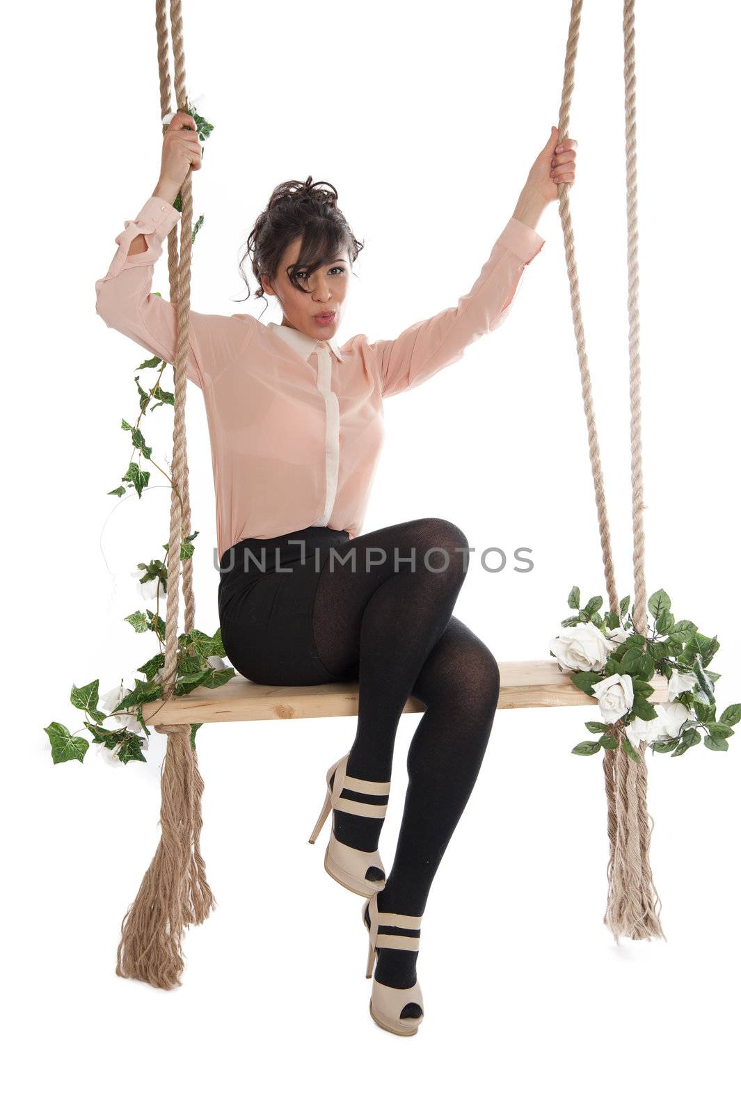 Emotional woman on a swing in the studio isolated background