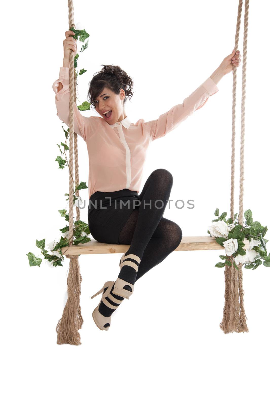 Emotional woman on a swing in the studio isolated background