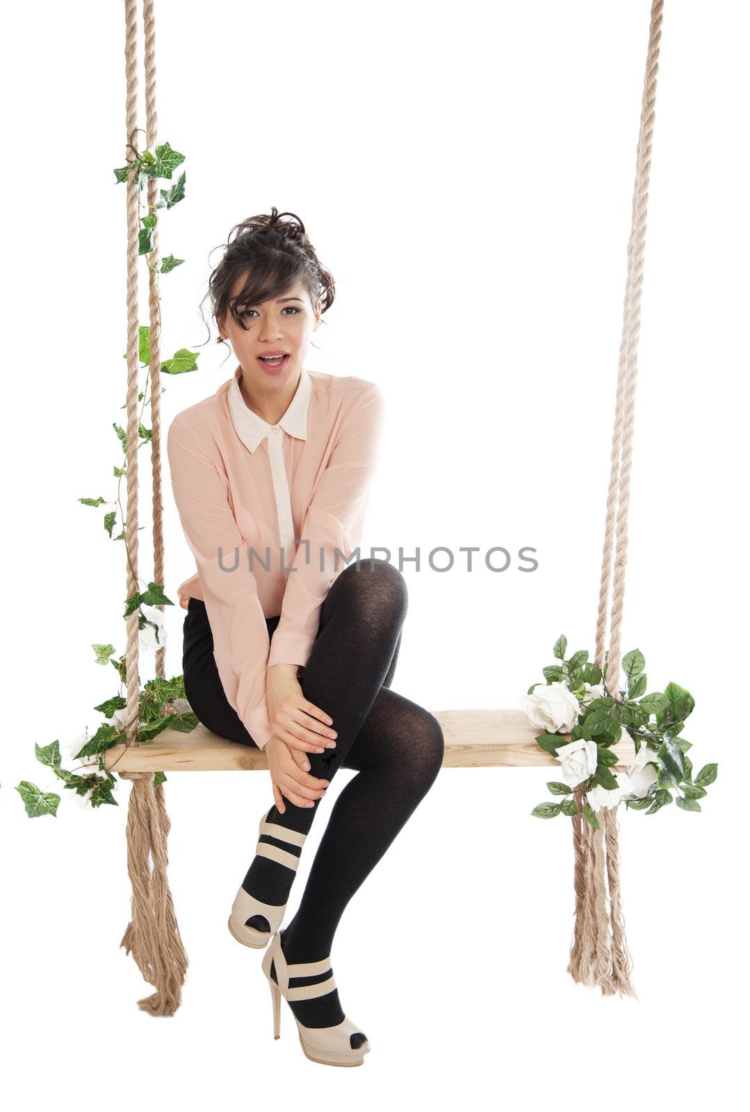 Emotional woman on a swing in the studio isolated background