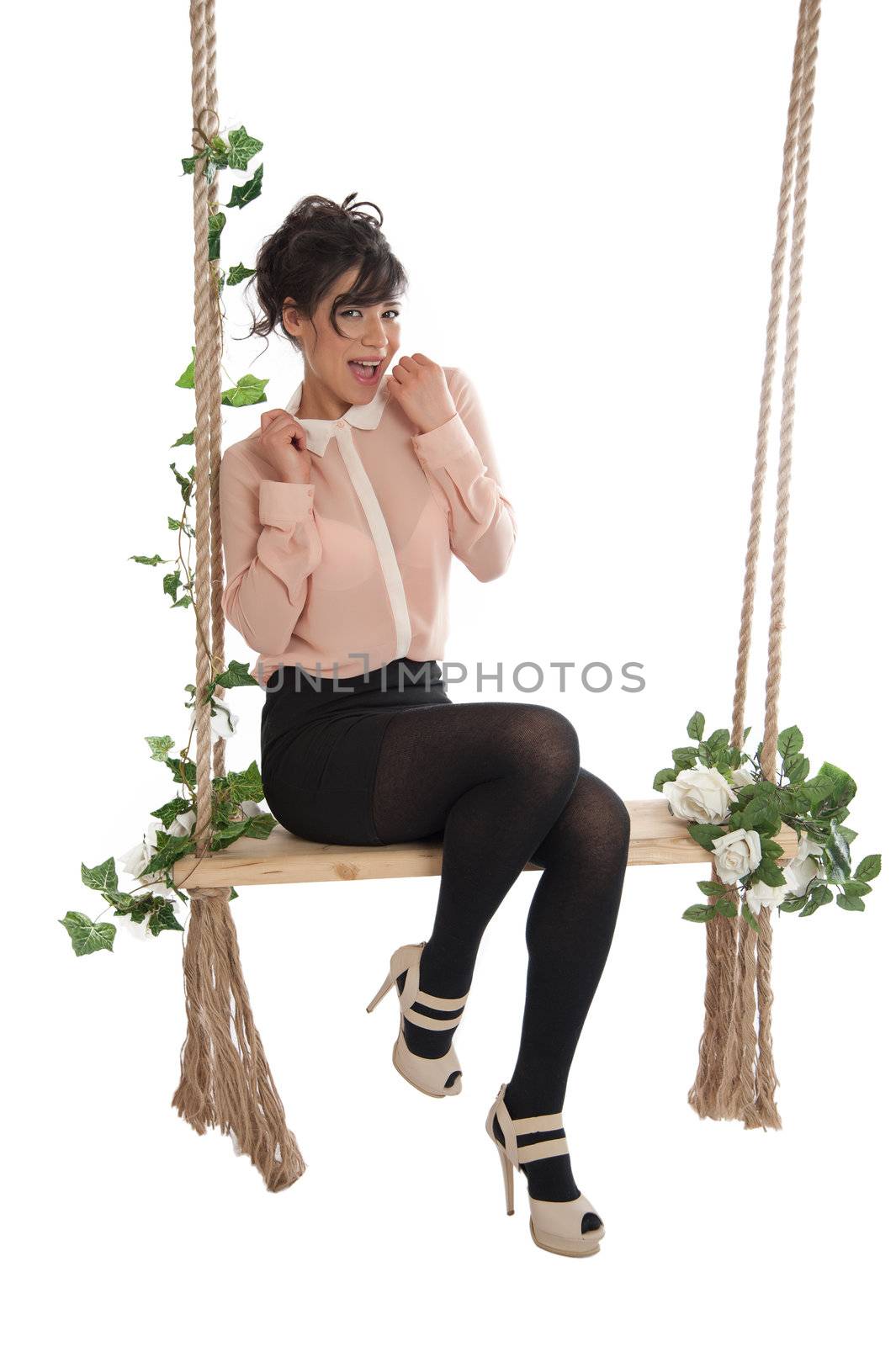 Emotional woman on a swing in the studio isolated background