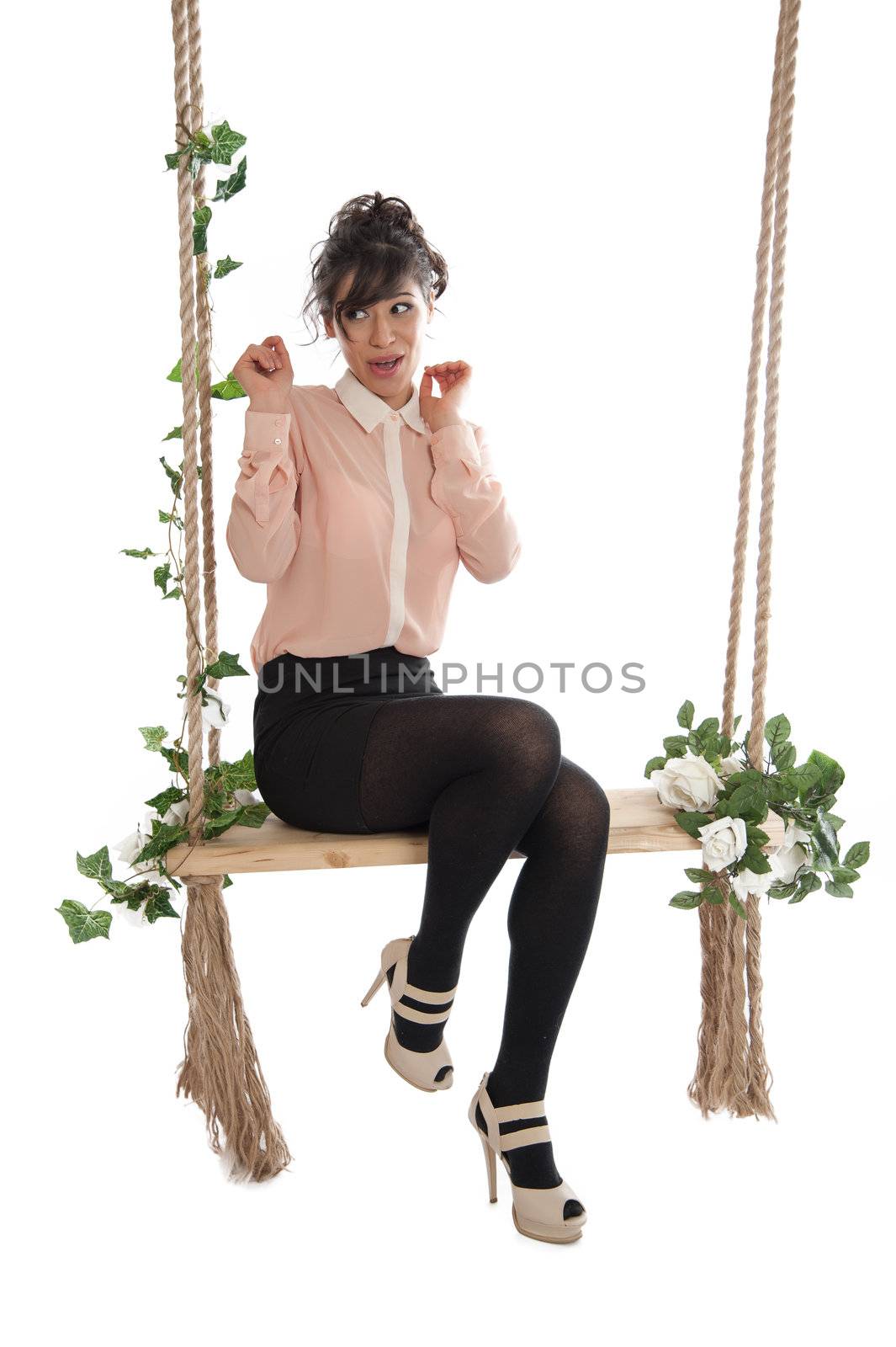 Emotional woman on a swing in the studio isolated background