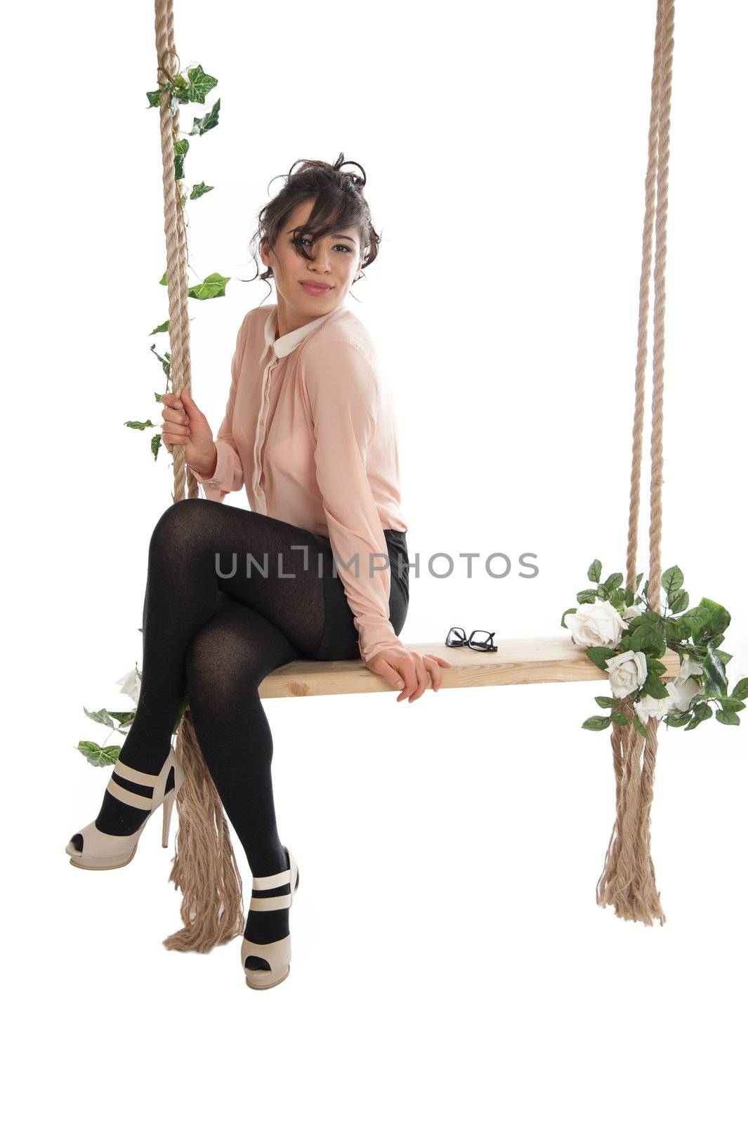 Emotional woman on a swing in the studio isolated background