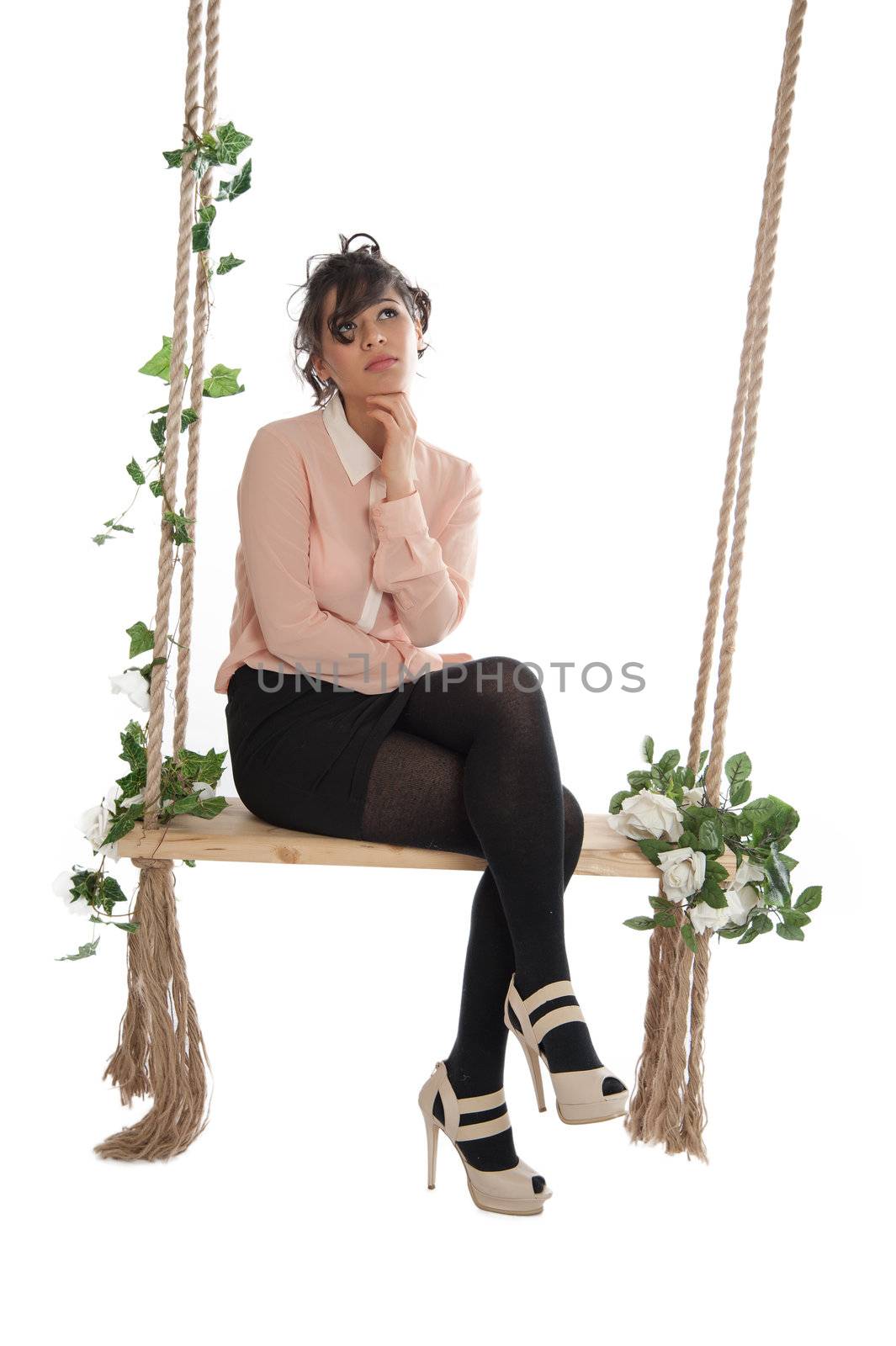 Emotional woman on a swing in the studio isolated background