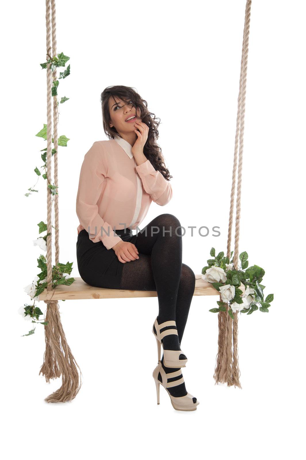 Emotional woman on a swing in the studio isolated background