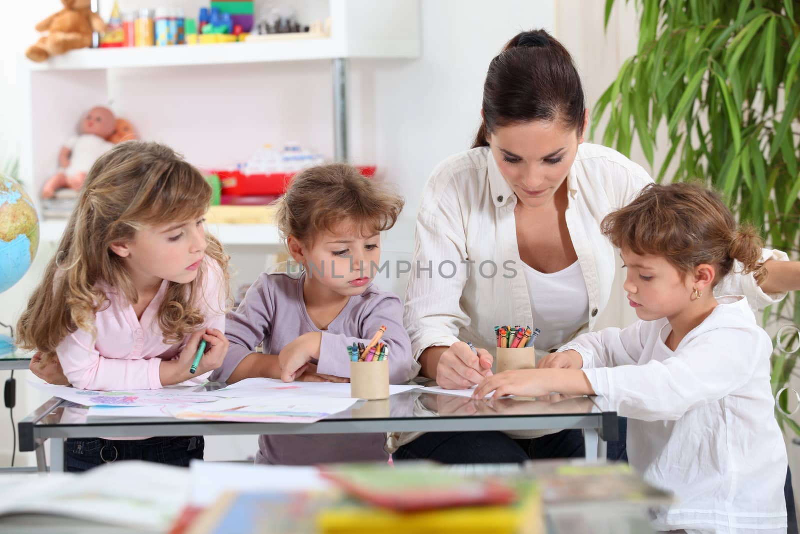 Woman helping a group of girls with their homework