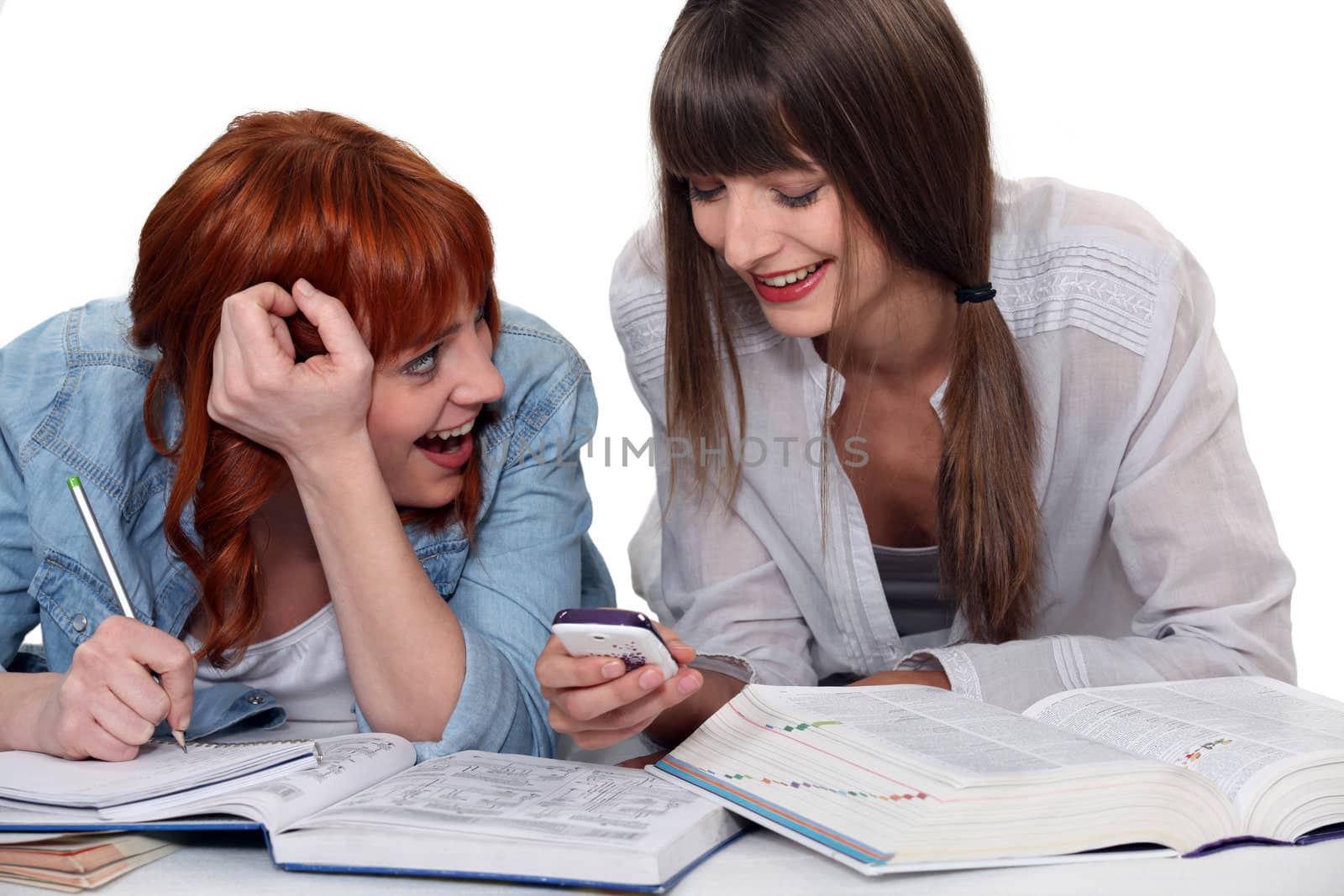 two girlfriends studying and having fun together