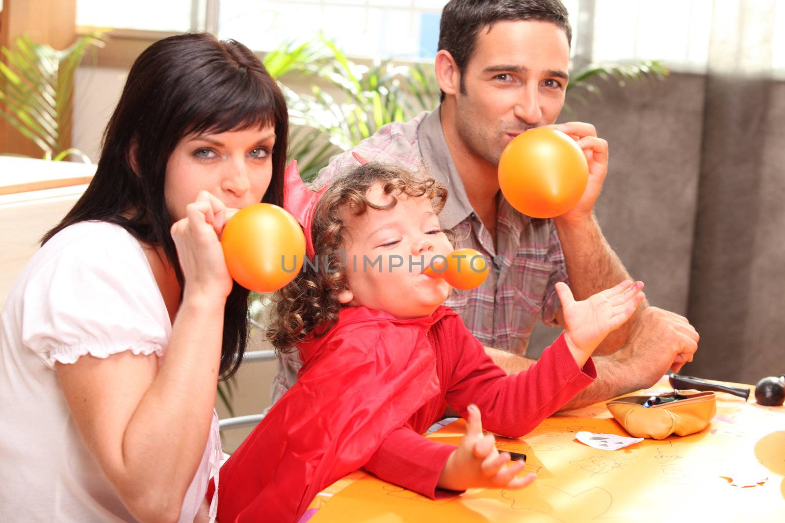 Family inflating balloons for Halloween by phovoir
