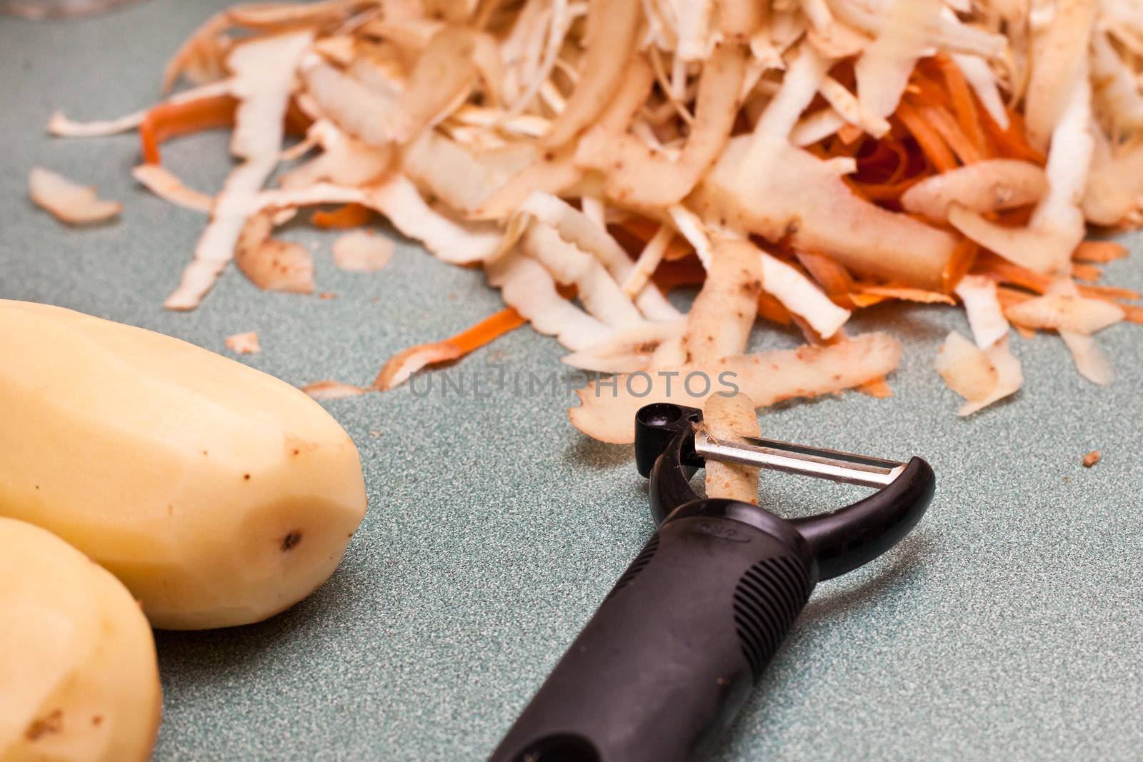 Potato and carrot peelings on a worktop