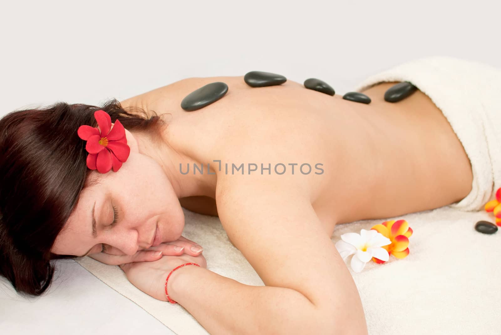 pretty female at spa center, stones relaxing therapy