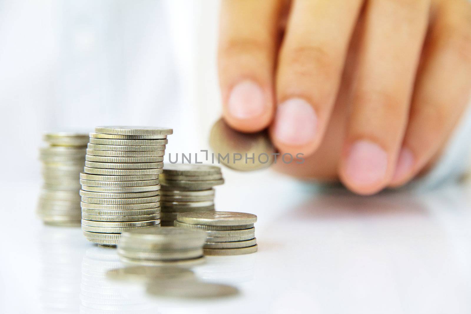 Hand put coin to stack, investment concept