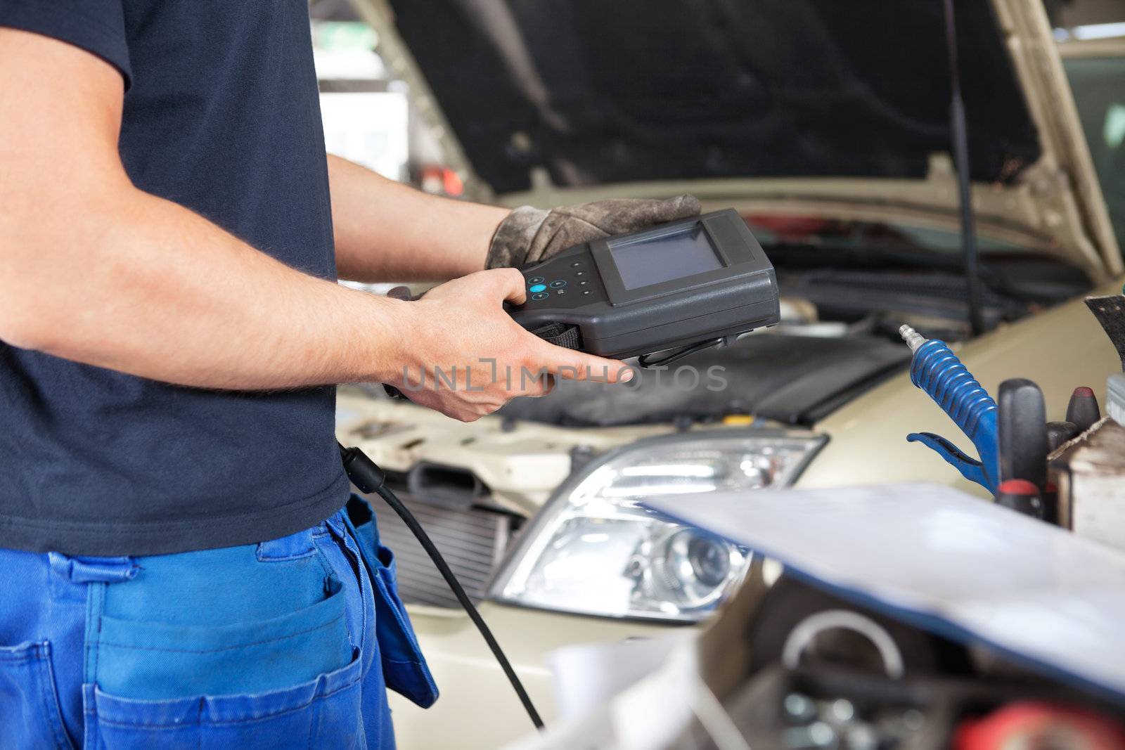 Mechanic using a Diagnostic Tool by leaf