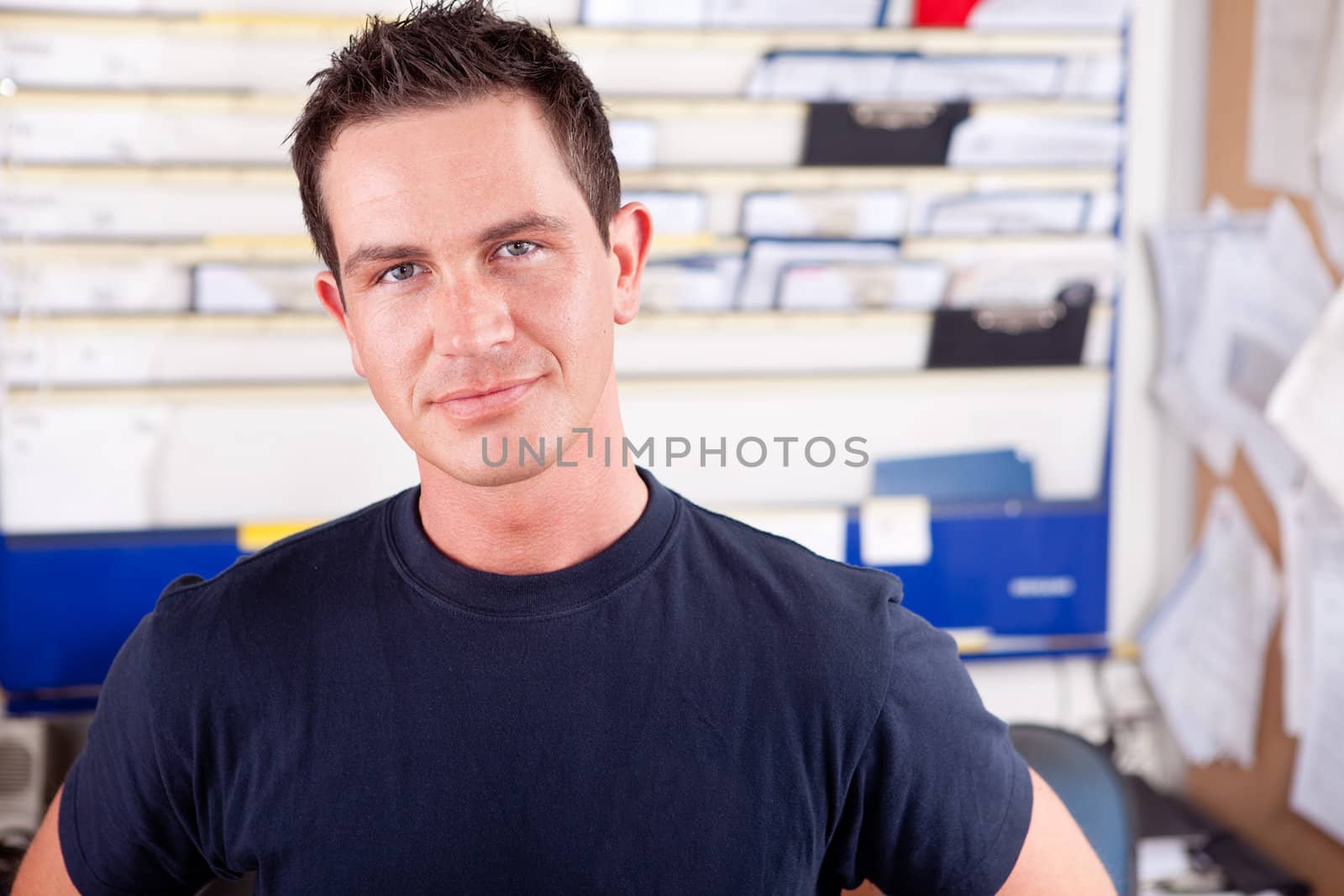 Portrait of a young man mechanic in office