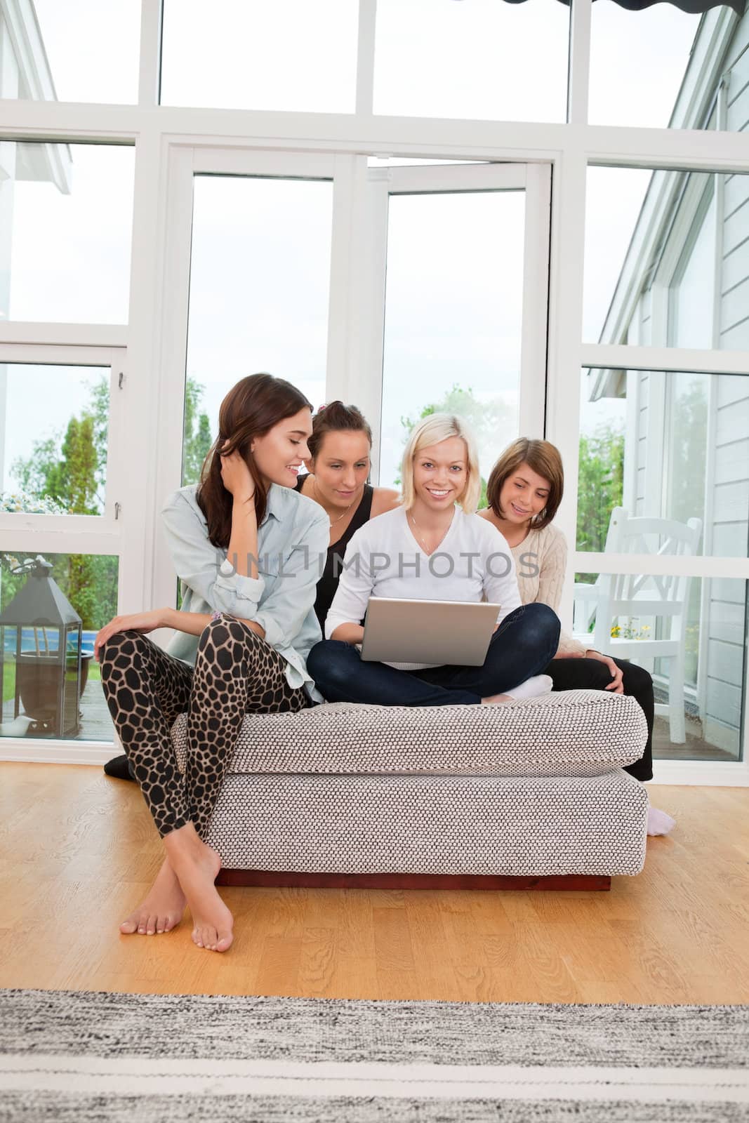 Women using laptop by leaf