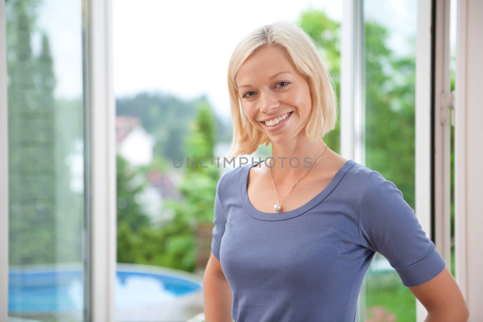 Pretty young woman smiling by leaf