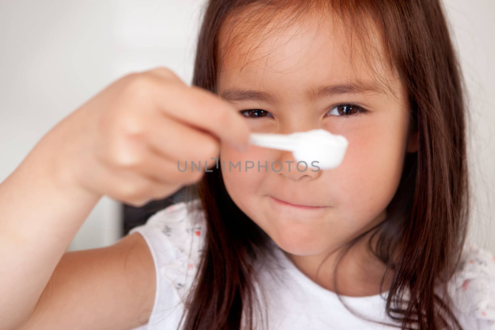 Young girl Measuring Ingredient by leaf