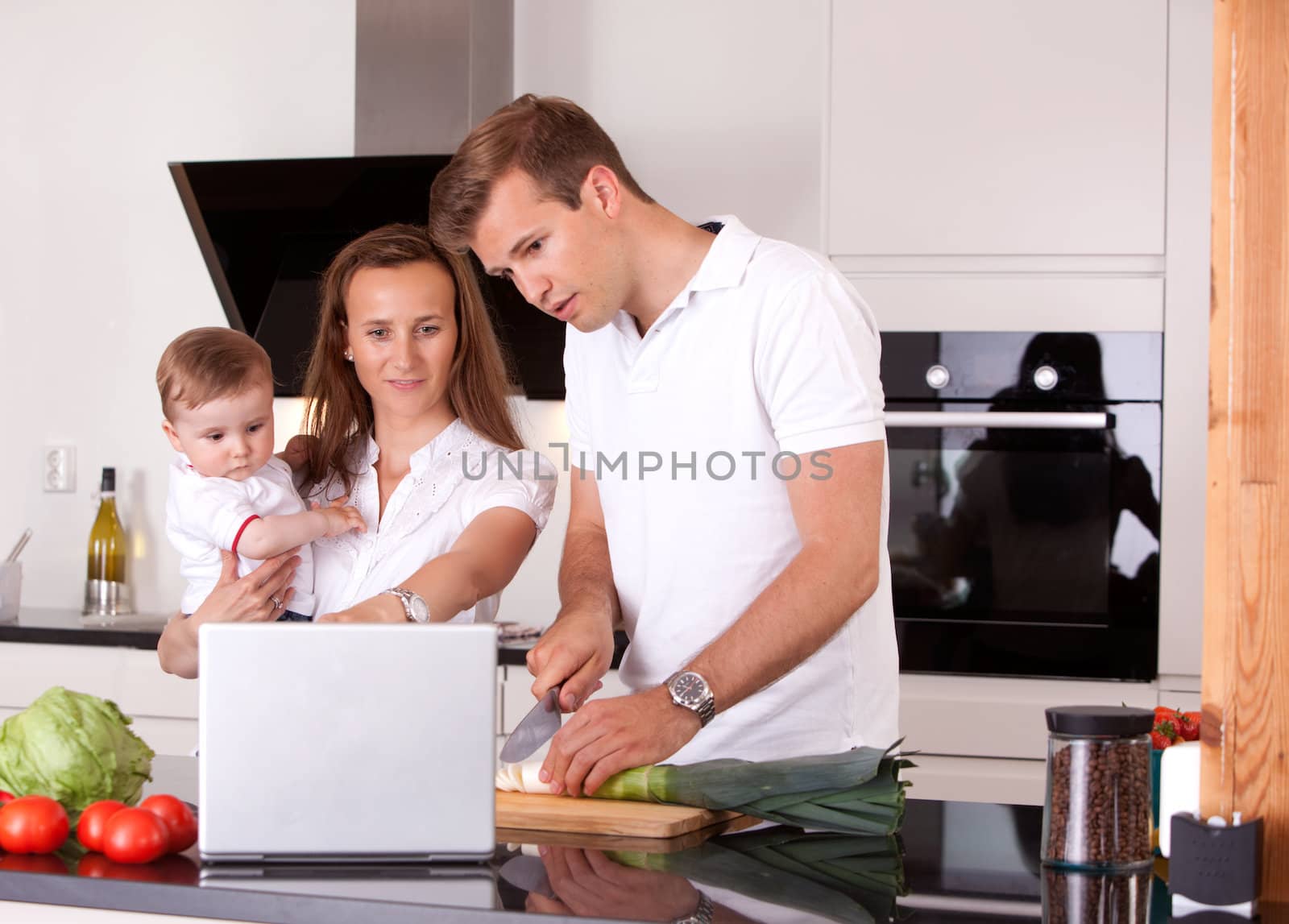 Family in Kitchen Preparing Meal by leaf