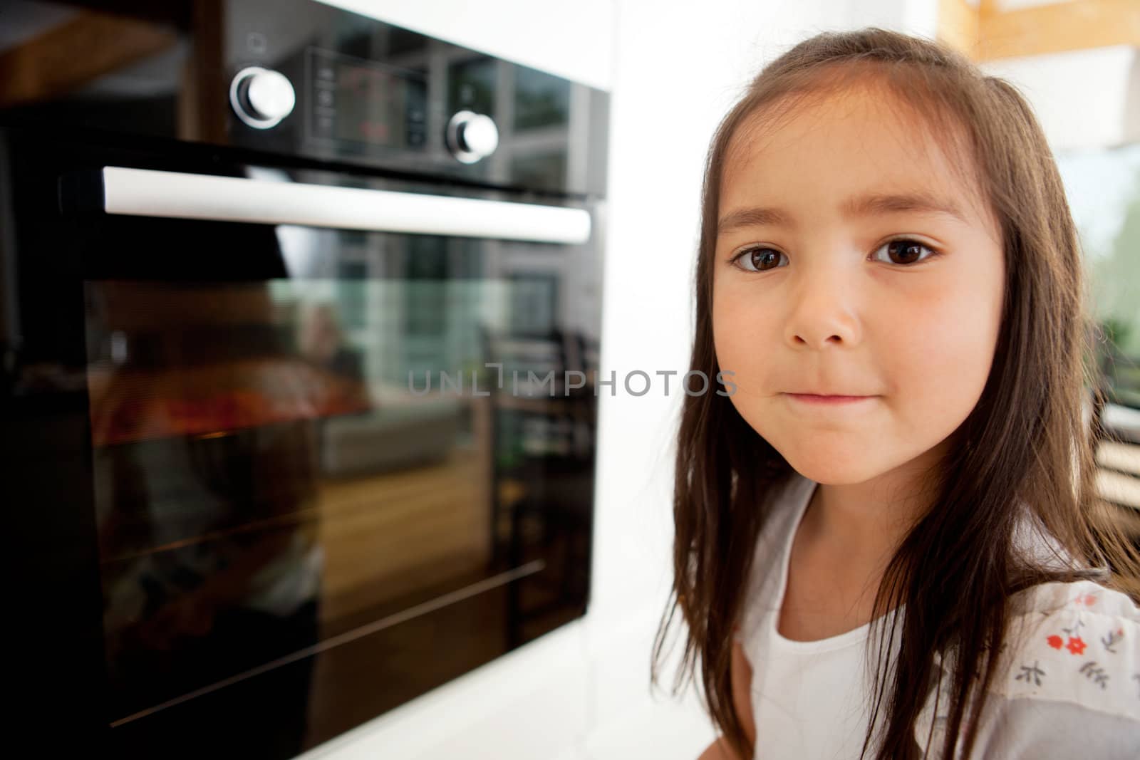 Young Girl Watching Cookies Bake by leaf