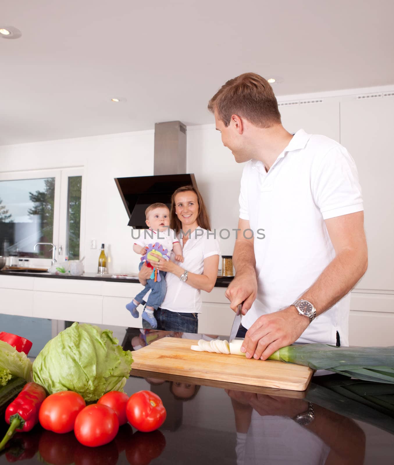 Mother, father and son in kitchen, shallow depth of field with critical focus on father