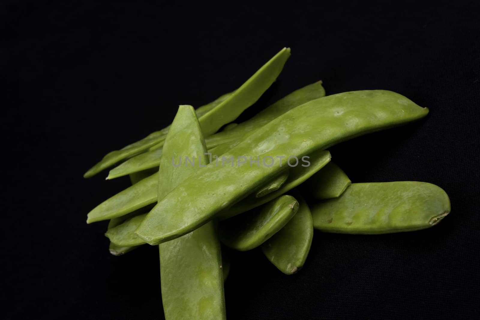 Mangetout Peas isolated on black background