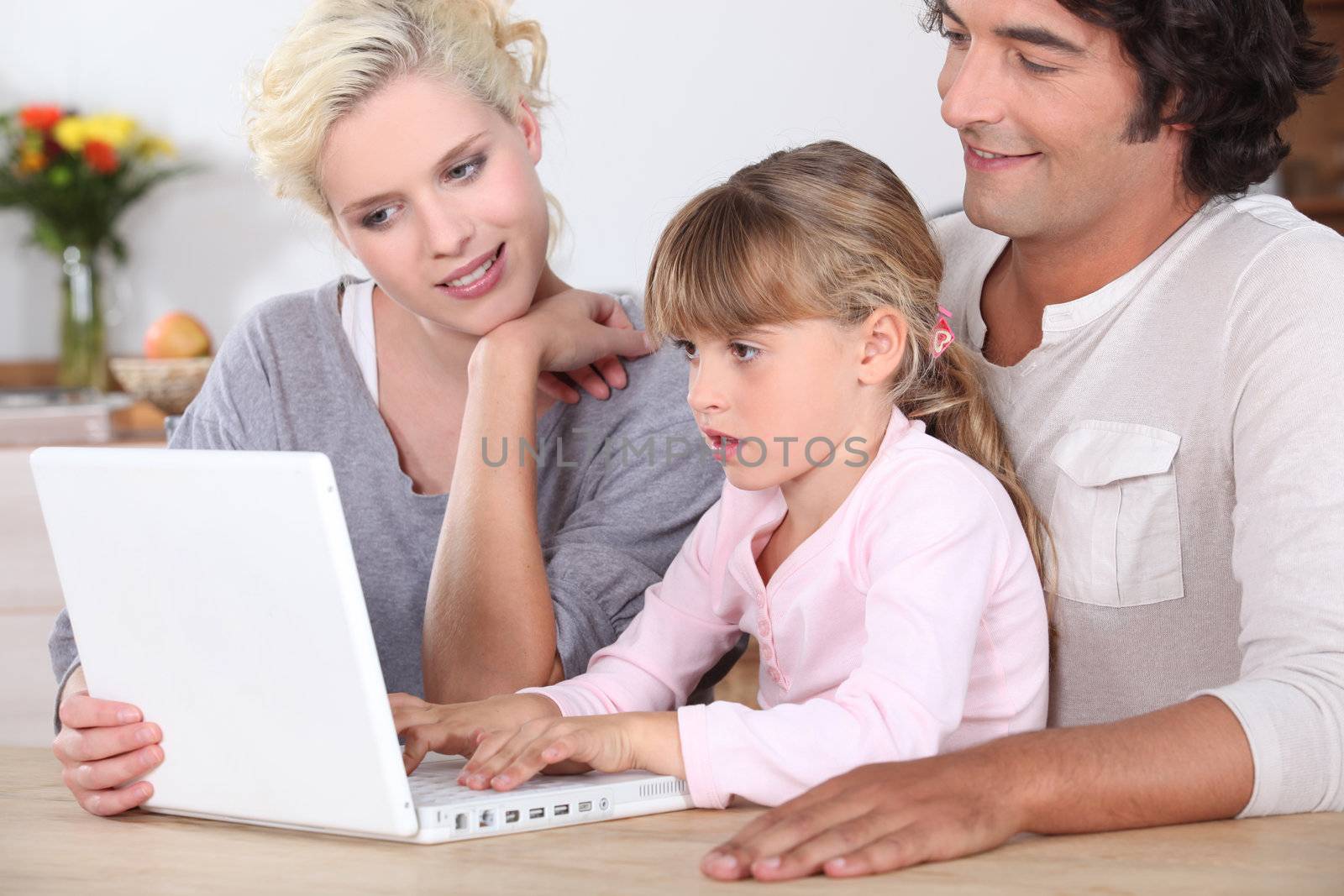 Parents with daughter and computer by phovoir