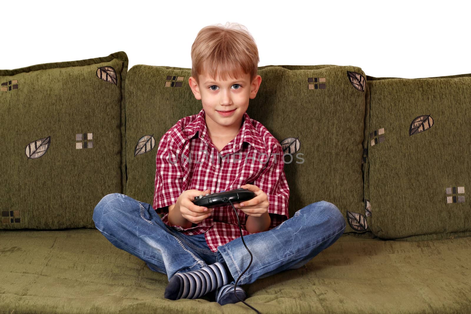 boy sitting on bed and play video game