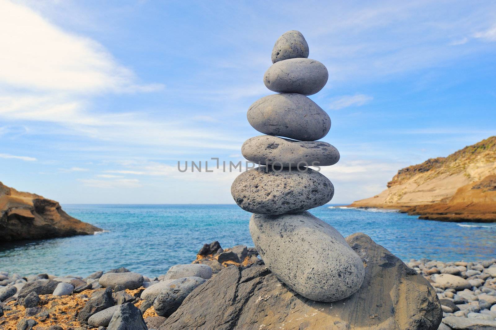 Pile of pebbles in the balance on the seacoast