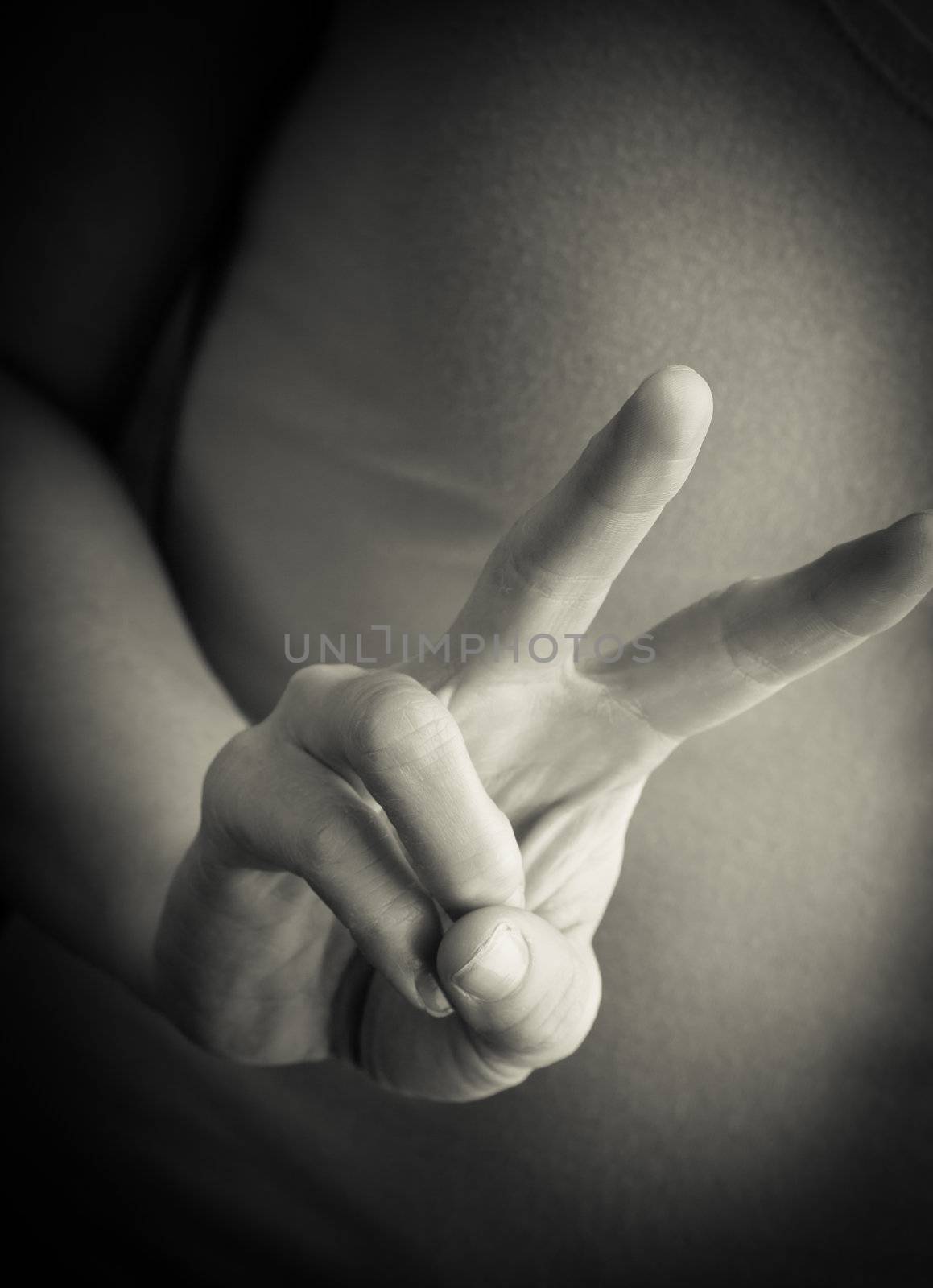 Human hand doing a Peace sign by Izaphoto