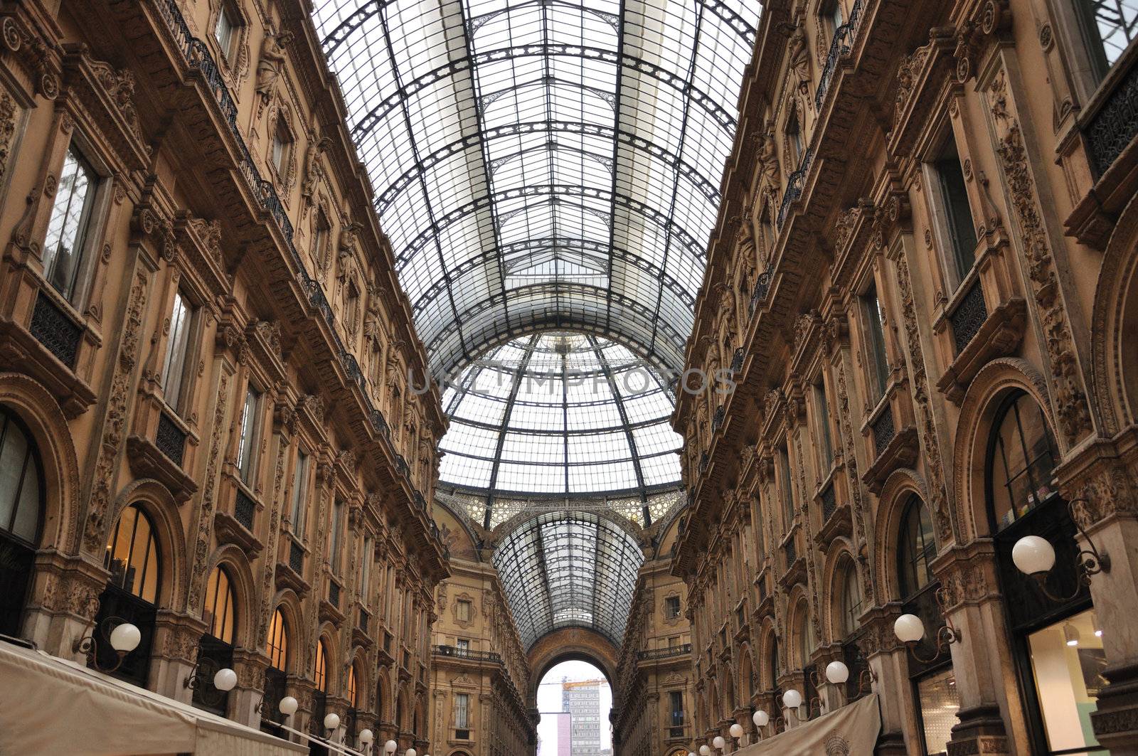 The Galleria Vittorio Emanuele II is a covered double arcade formed of two glass-vaulted arcades at right angles intersecting in an octagon; it is prominently sited on the northern side of the Piazza del Duomo  in Milan, and connects to the Piazza della Scala.