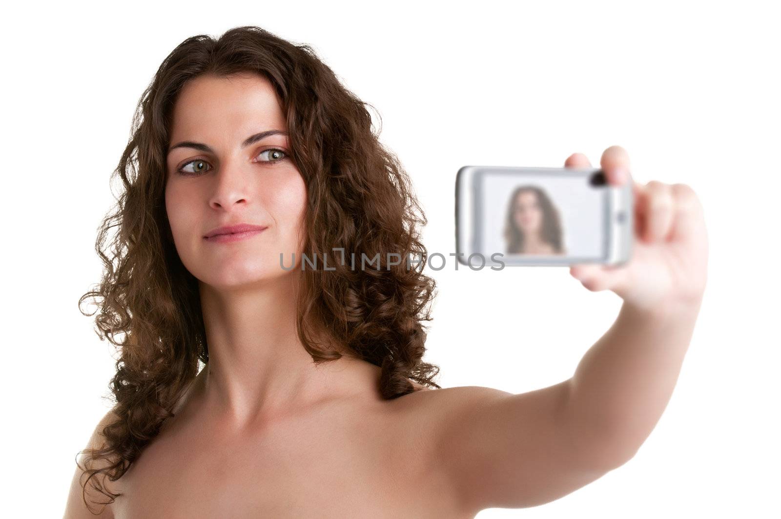 Young woman taking a picture of herself with a cell phone, isolated in a white background