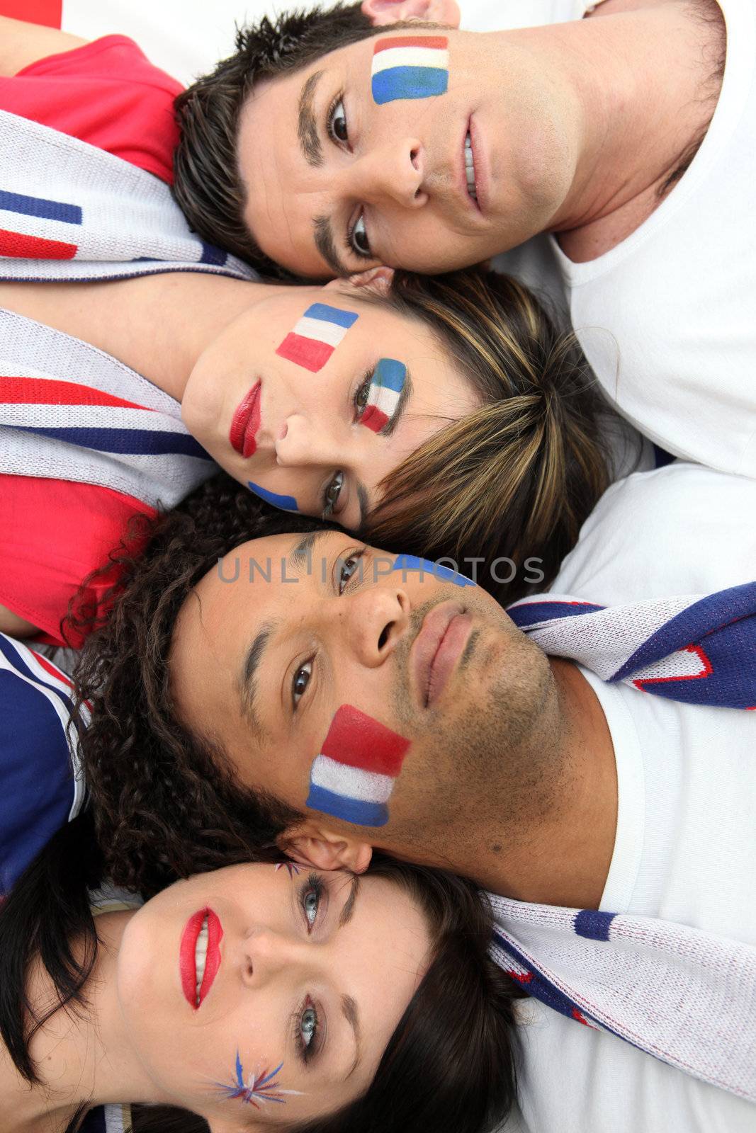 Four French sports fans laying together by phovoir