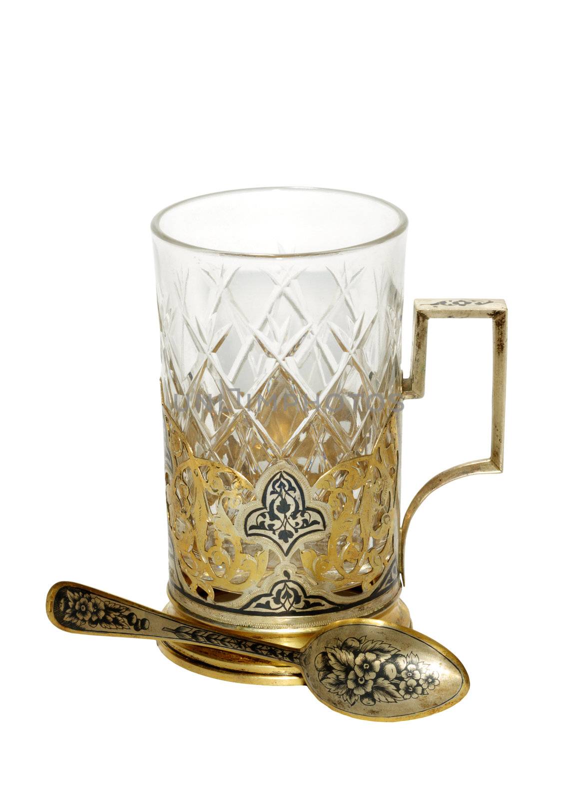 Antique gold holder with crystal glass and a gold spoon. Isolate on white background