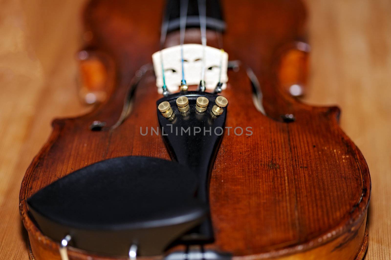 Antique violin and bow on faded wooden table background