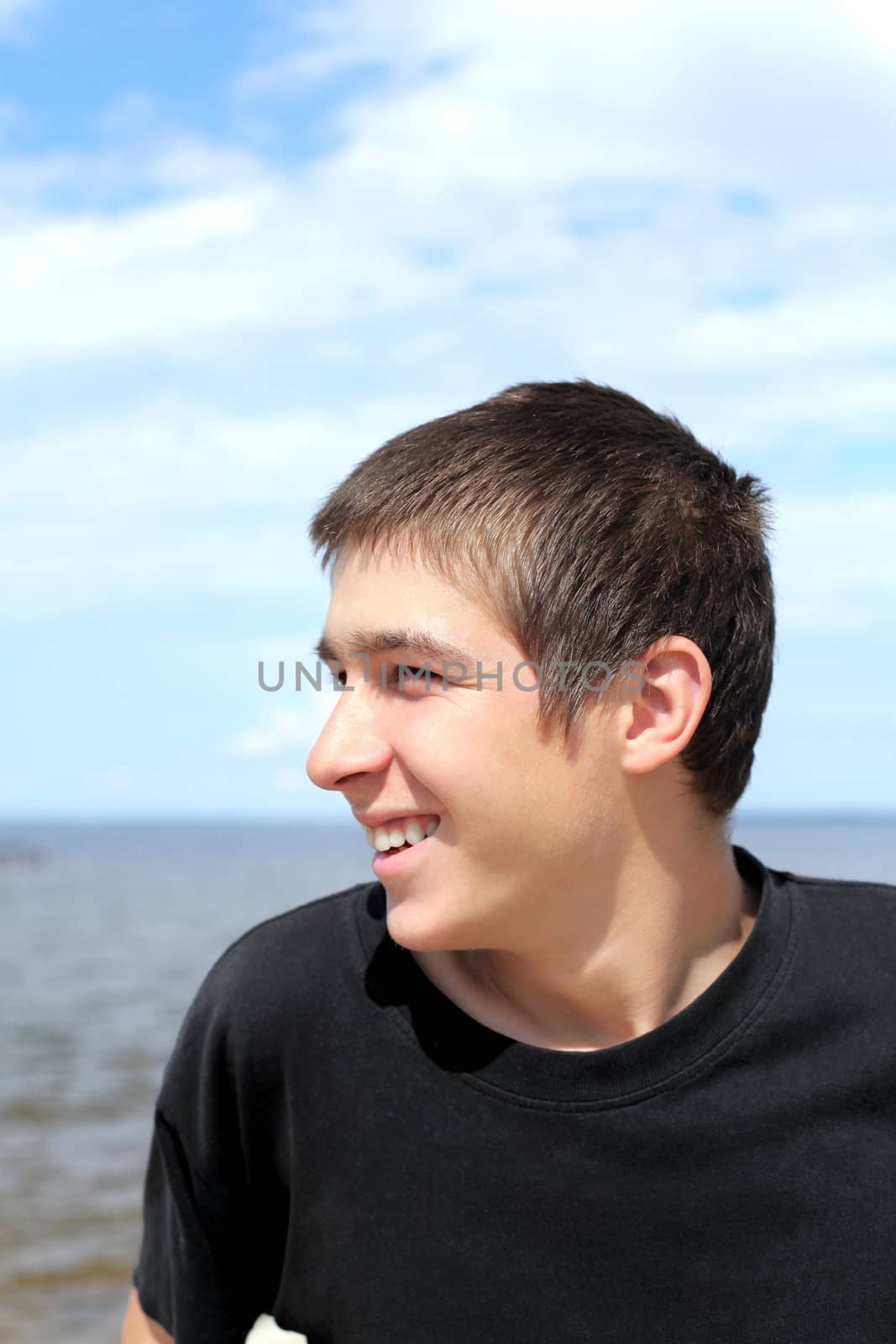 happy young man against seaside background