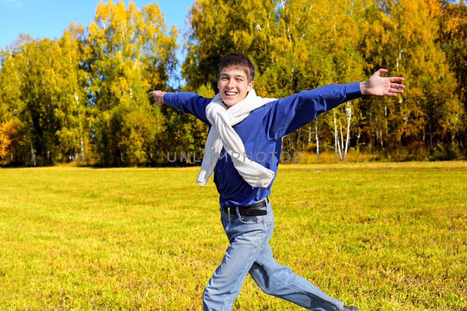 happy teenager running in the autumn forest