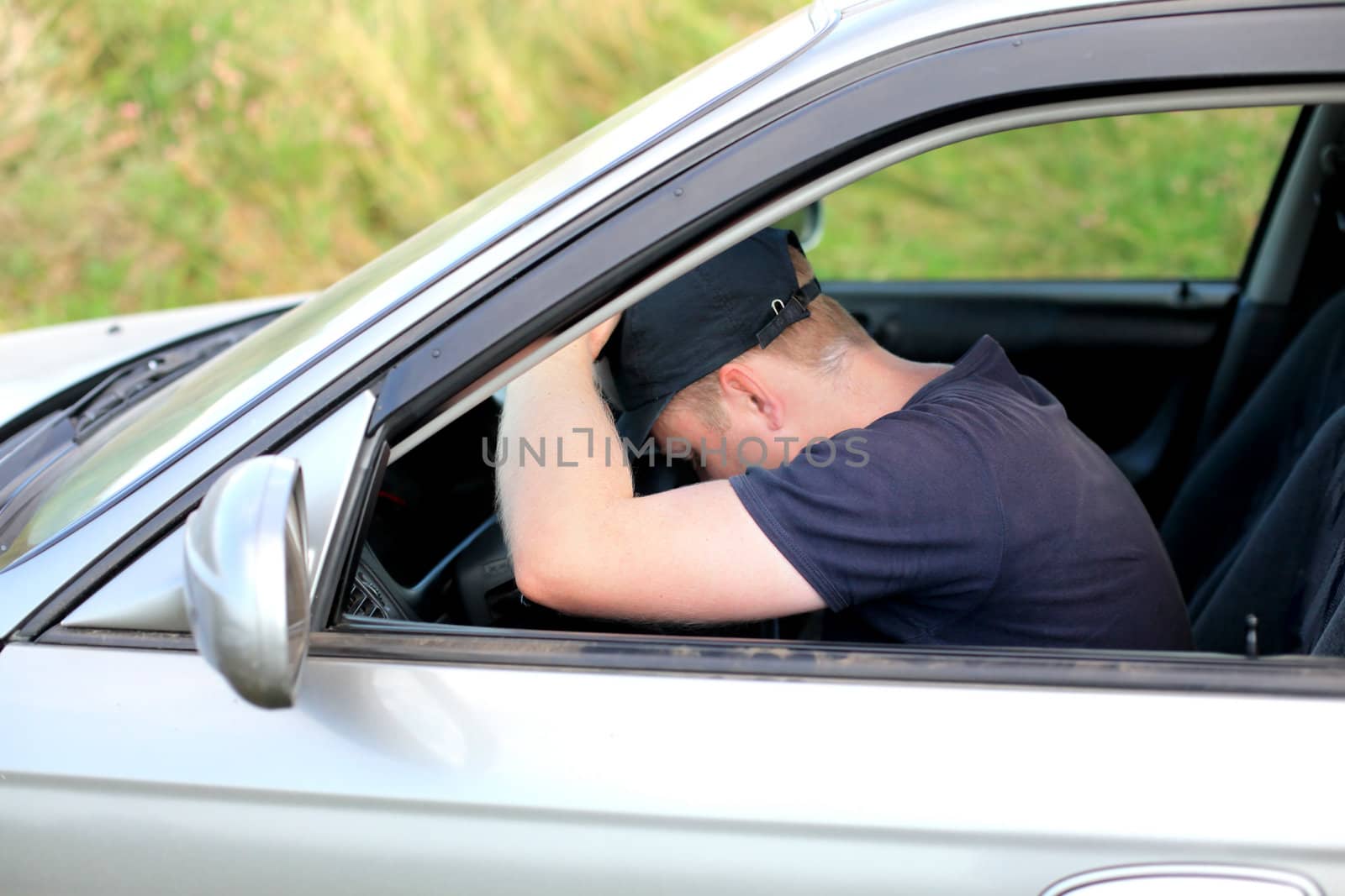 tired man fall asleep in a car