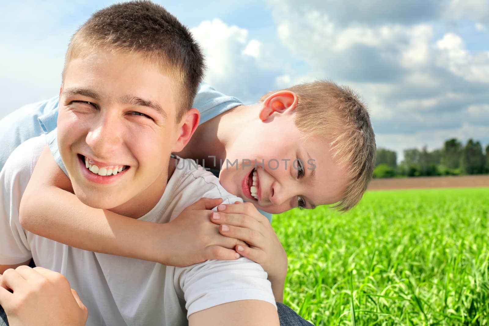 happy brothers in the summer field