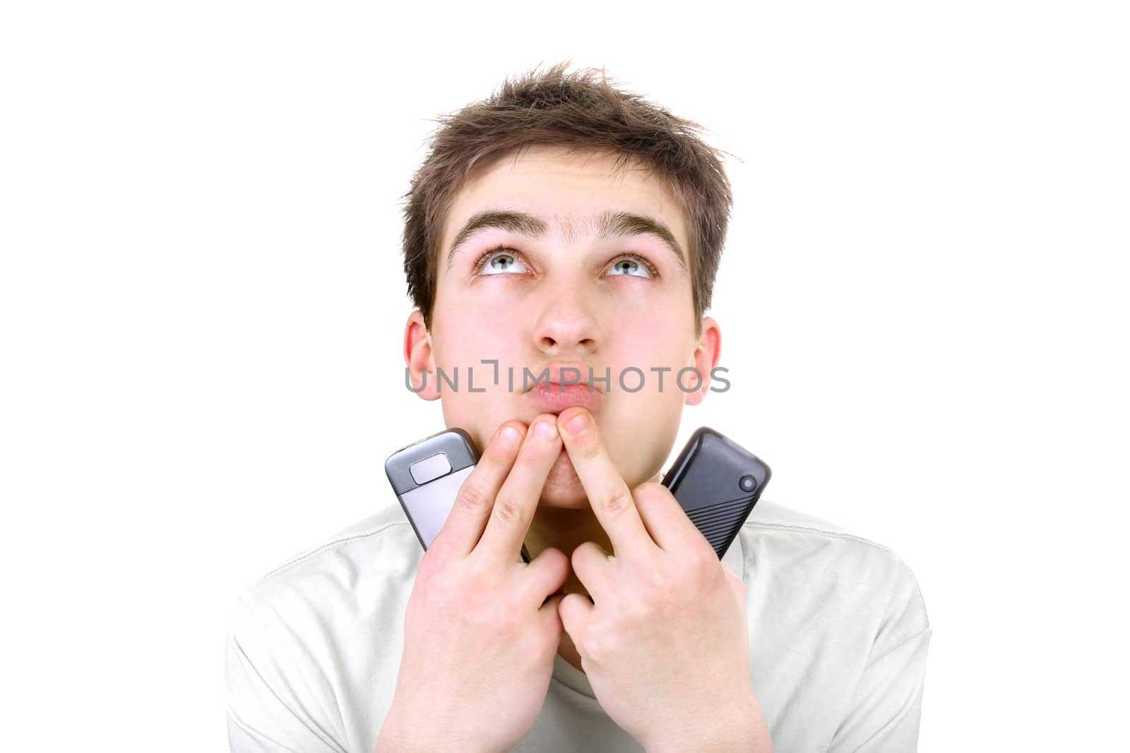 young man is thinking with two mobile phones on the white background