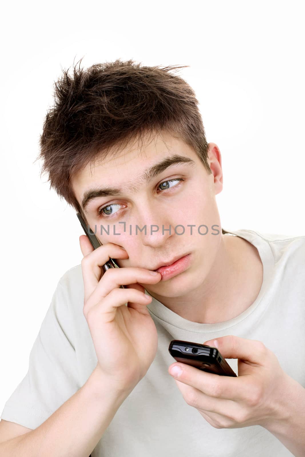 sad young man looking on the mobile phone. isolated on the white