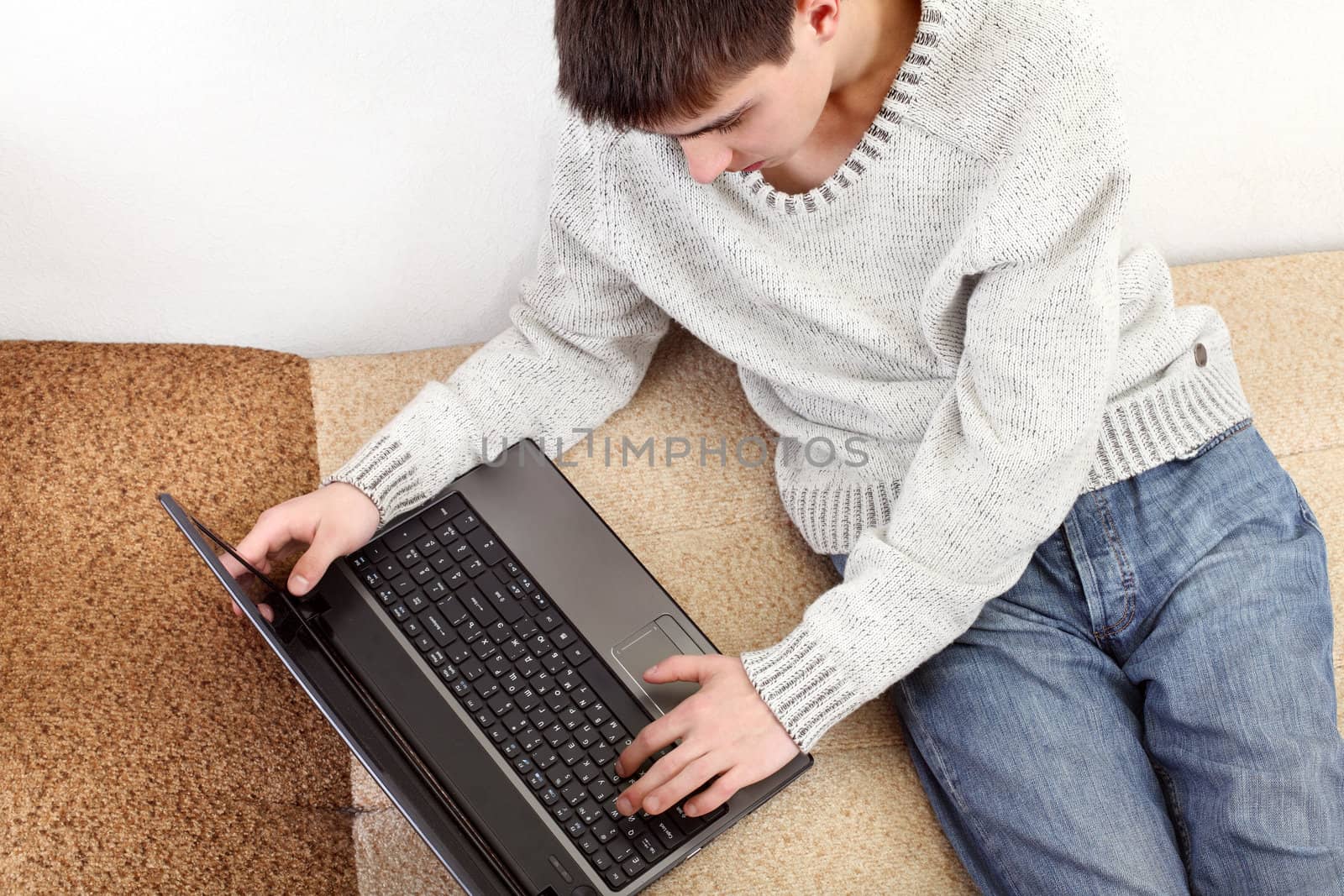 young man with notebook on sofa