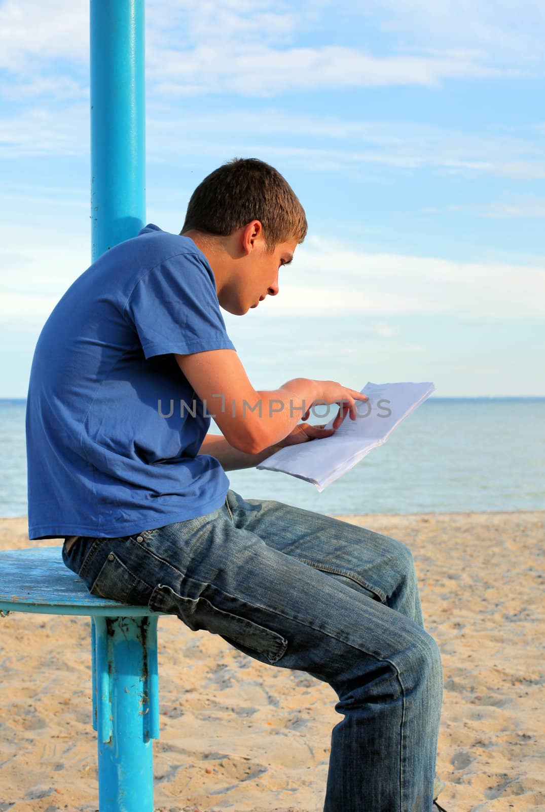 teenager reading letter on the empty beach