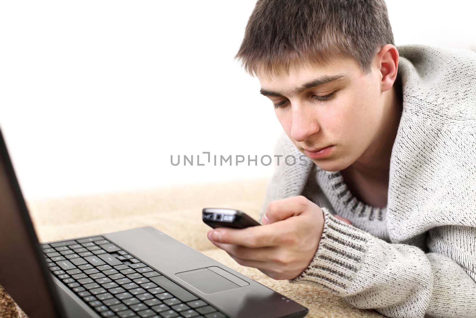 teenager with notebook and mobile phone in home interior