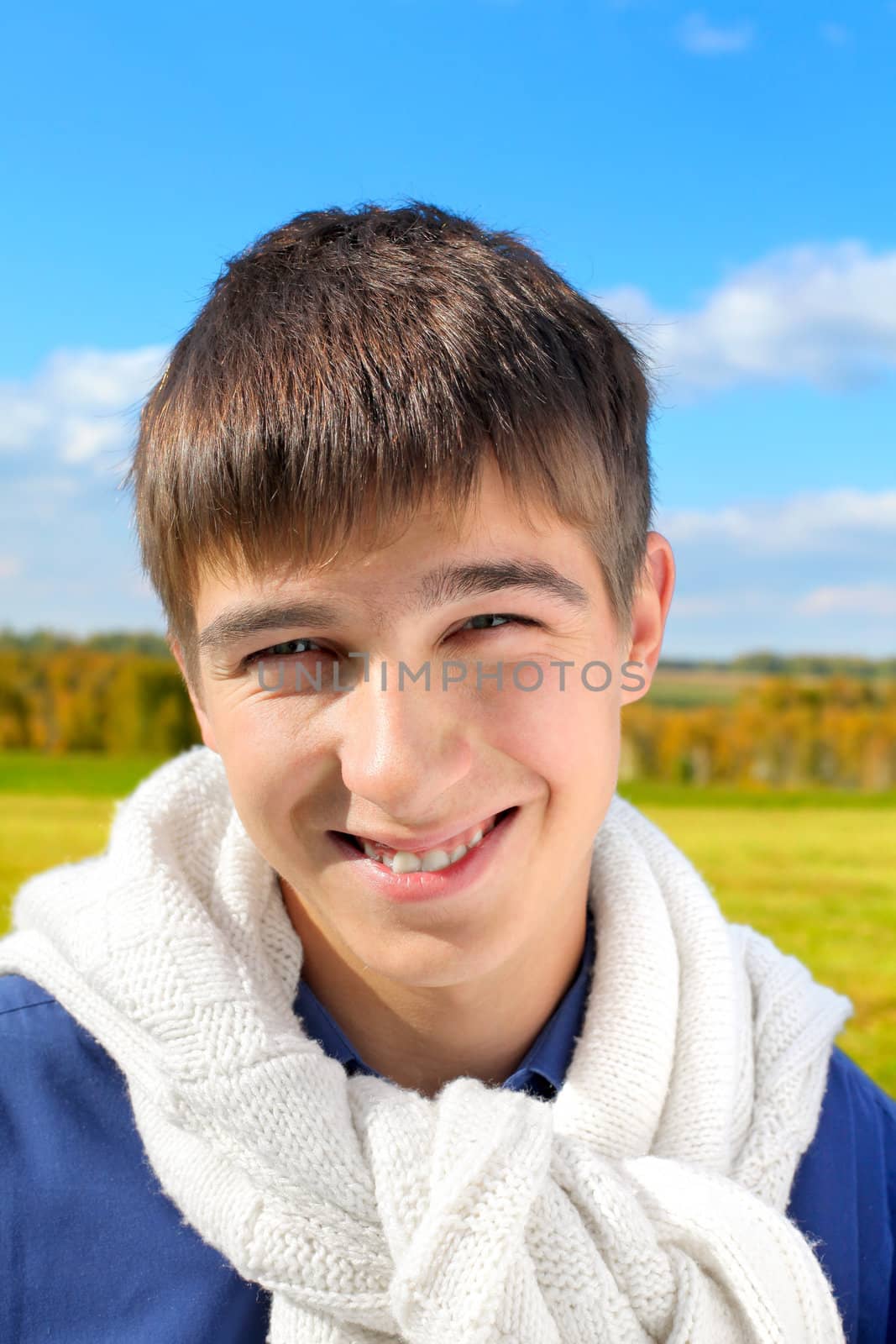happy and smiling teenager portrait in the autumn field