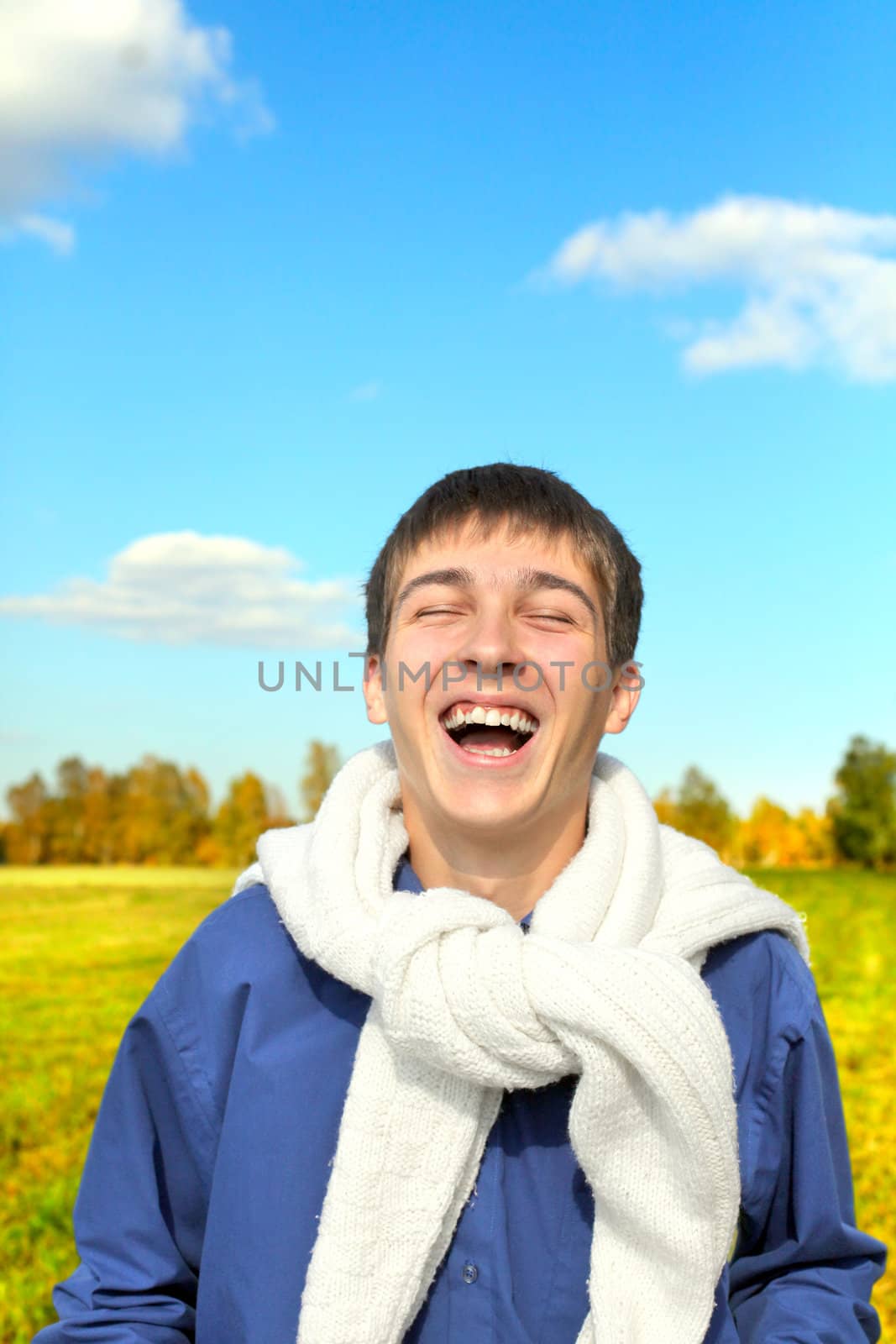 happy and smiling teenager portrait in the autumn field