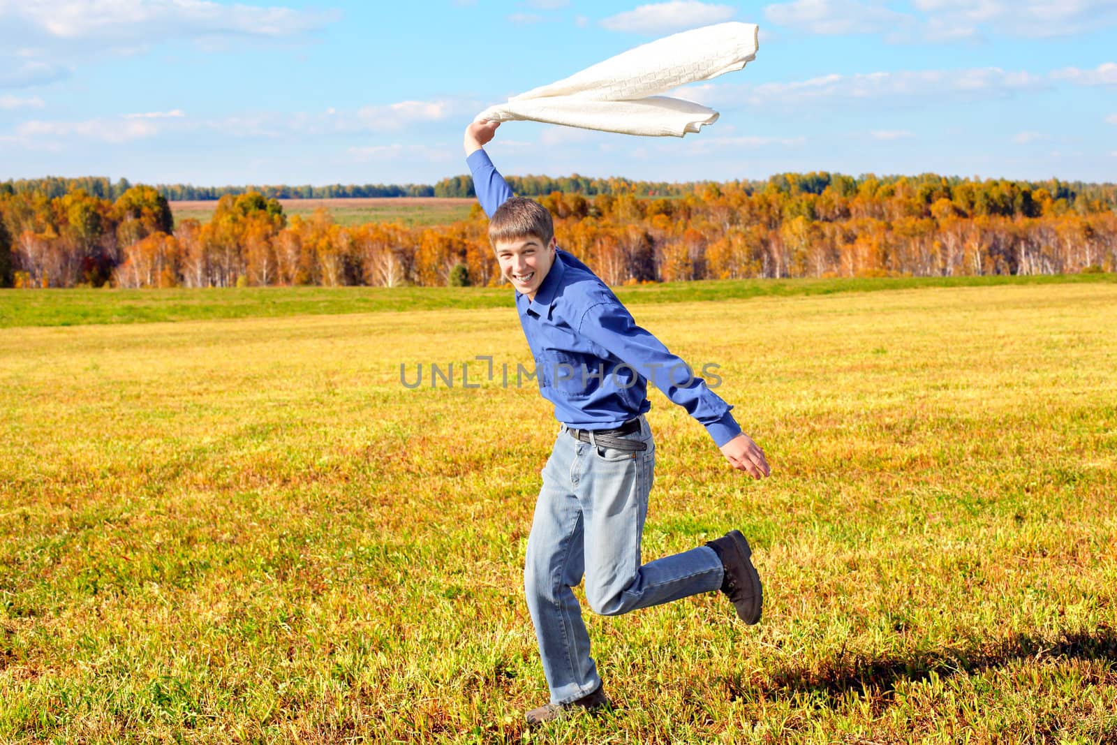 happy teenager running on the autumn field