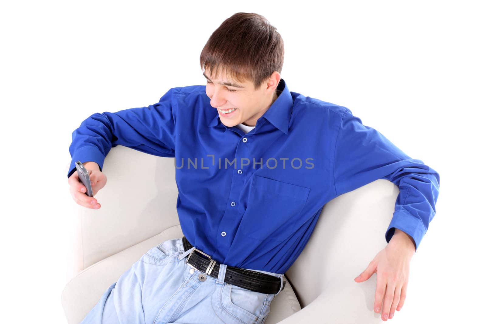 happy teenager with mobile phone in a chair on the white background