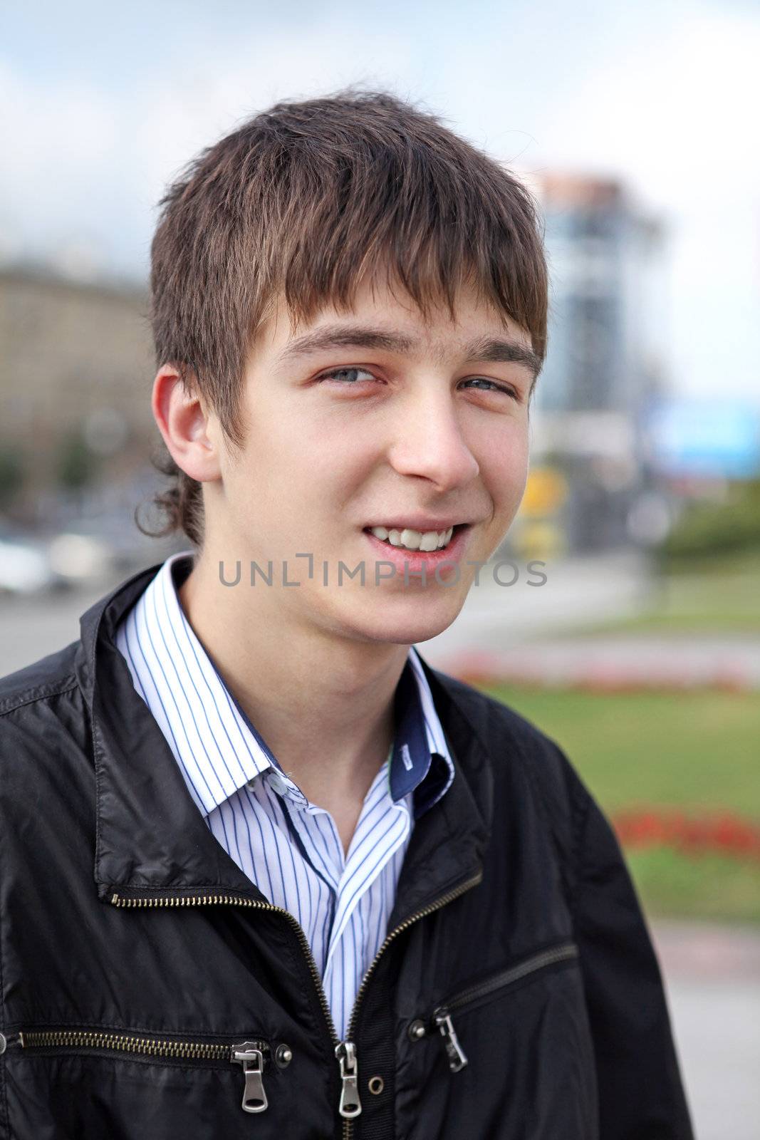 portrait of smiling teenager on the city street