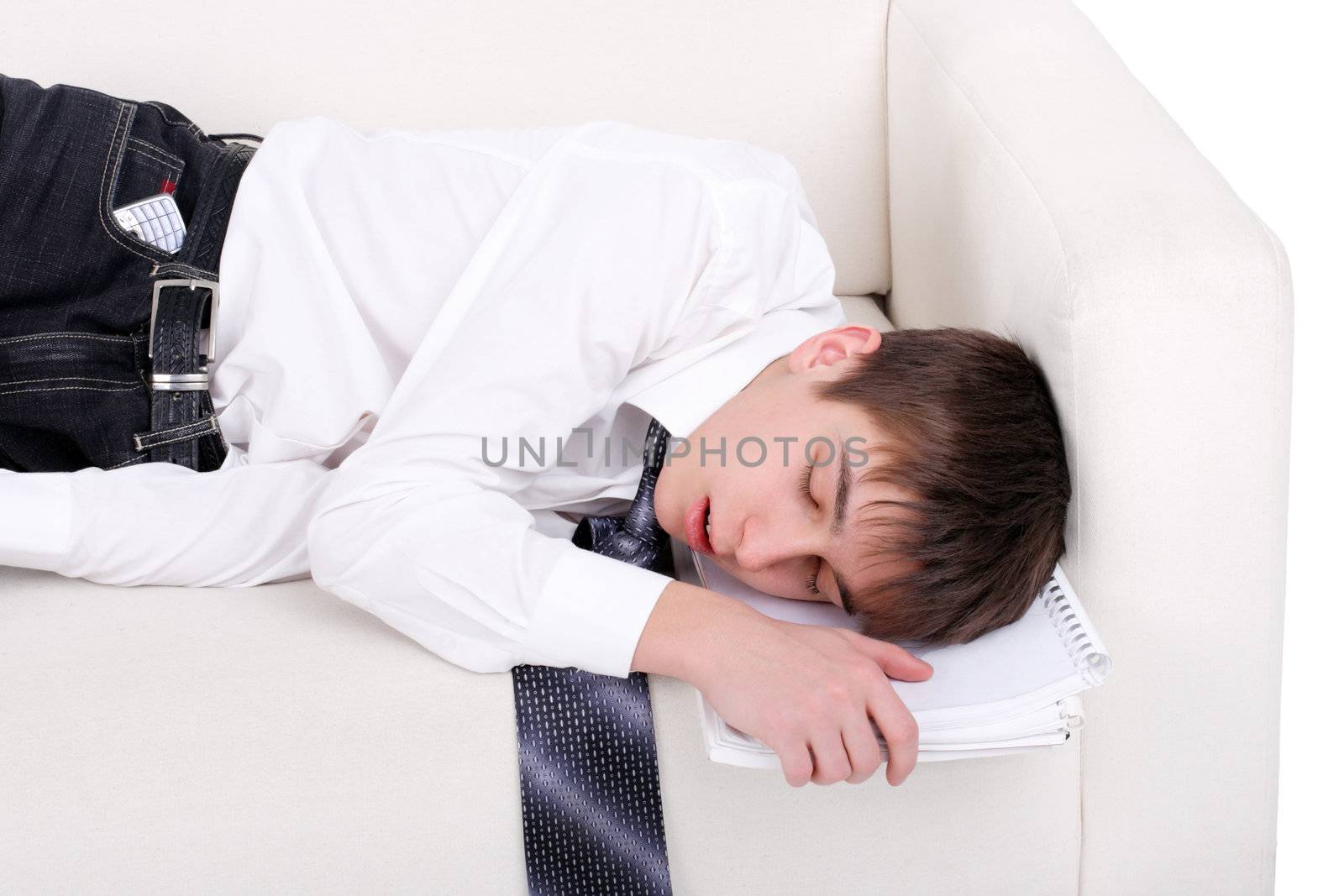 Tired Teenager sleeping on the Sofa with his books